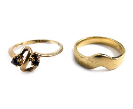 Two 9ct gold dress rings, comprising a 9ct gold wishbone dress ring, ring size K½, and a further dress ring, of scroll design