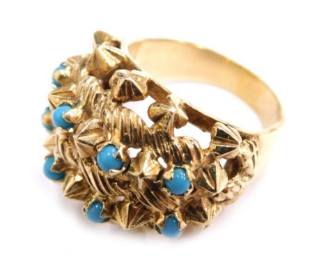 A 14ct gold cluster ring, claw set with eight turquoise on a plain shank, marked 585, size O, 10.7g all in.