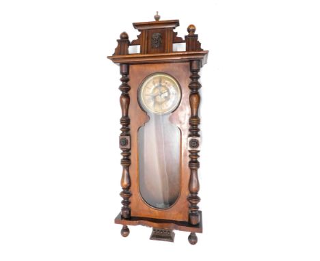 A late 19thC walnut cased Vienna wall clock, the 17cm diameter Roman numeric dial fronted by a glass panel and flanked by qua