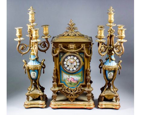 A late 19th Century French gilt metal and porcelain mounted three piece clock garniture, No. 2691, the 3.5ins diameter porcel