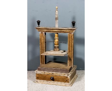 An 18th Century Dutch oak print, or book, press, the turned screw of elm, with turned ebony knops to top, and with single dra