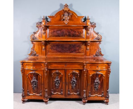 A late 19th Century French mahogany sideboard of large proportions, the arched and shaped panel to back with moulded cornice 