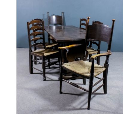 A 20th Century oak refectory table, the three plank top on shaped and fretted end supports with trestle feet and plain stretc