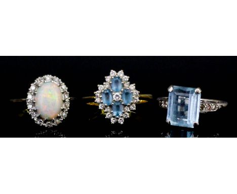 An 18ct gold and platinum mounted white opal and diamond oval cluster ring set with central white opal (approximately 9mm x 7