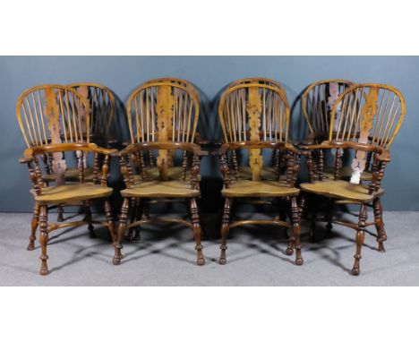 A set of eight 20th Century "Yorkshire" yew and elm seated stick back Windsor armchairs, the two tier stickbacks with shaped 