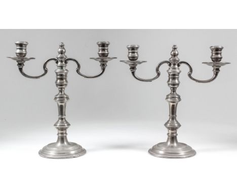 A pair of Elizabeth II silver two light candelabra, each with double C scroll branches and knop stems on circular moulded bas