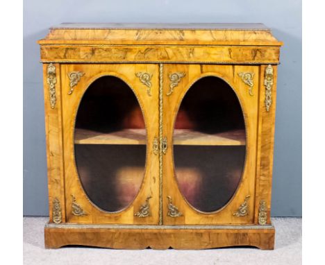 A Victorian figured walnut and gilt metal mounted dwarf display cabinet, inlaid with crossbandings and stringings, fitted one