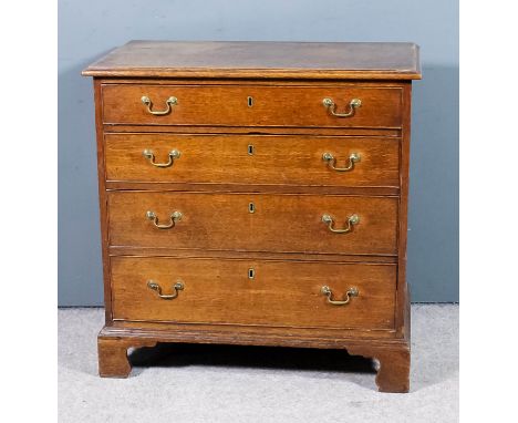 A George III oak chest of small proportions, the two plank top with moulded edge, fitted four long graduated drawers with ori