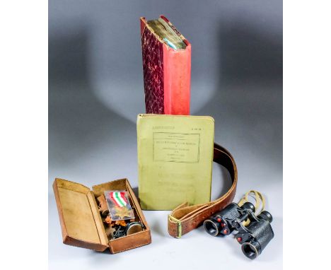 A small collection of World War II ephemera, including - A leather officers belt dated 1940, a pair of military binoculars by