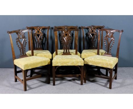 A set of six 18th Century mahogany dining chairs of "Chippendale" design, the shaped and moulded crest rails with leaf carvin