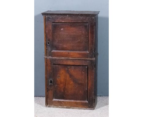 A small old oak two tier cabinet, the upper part with moulded cornice, fitted seven small drawers and open niche, enclosed by