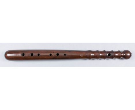 An early 20th Century turned rosewood truncheon with fingerholes for a recorder, stamped "Rugd 28149 H.S.", 15.5ins