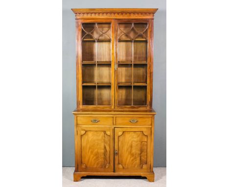 A George III mahogany bookcase, the upper part with moulded cornice with Greek key ornament and pendant drops, fitted three s