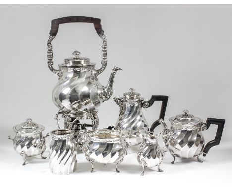 A late 19th/early 20th Century Dutch silver seven-piece tea service with bulbous spiral fluted bodies and some on three cast 