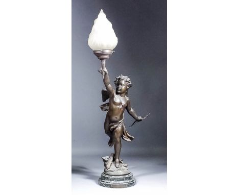 An early 20th Century bronzed spelter electric table lamp, modelled as a cherub holding aloft a flaming torch, on green veine