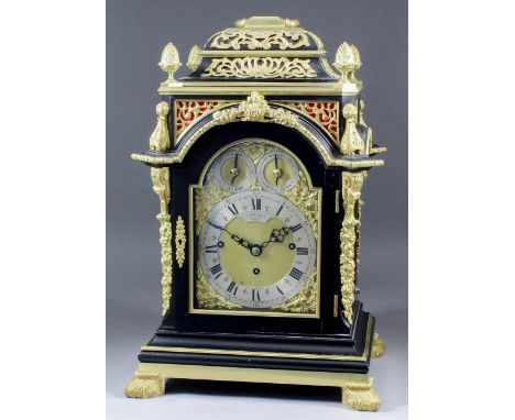 A late Victorian ebonised and gilt brass cased mantel clock by A. & H. Rowley, 180 Grays Inn Road, London, the 6ins arched br