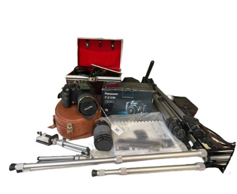 Collection of cameras, lenses, tripods, including Olympus, Panasonic, Canon, etc.