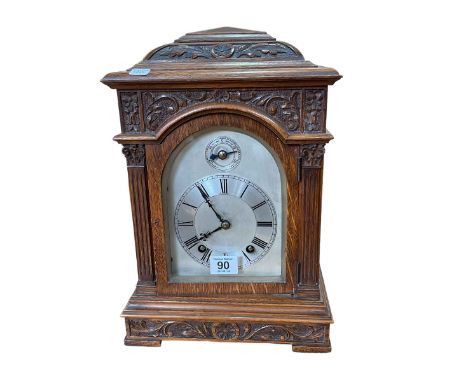 Carved oak bracket clock, 36cm high.