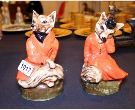 Pair of fox figurines wearing hunting pinks
