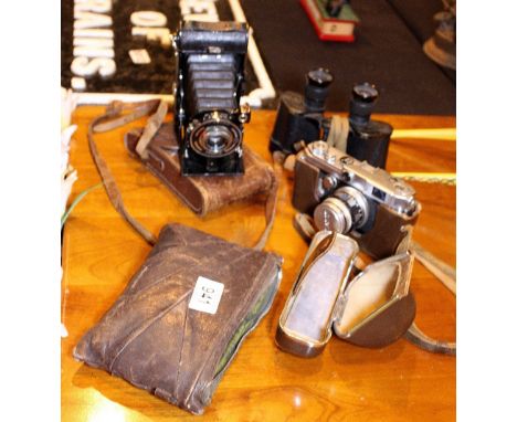 Two antique cameras, a retro Cannon camera and a pair of War Department binoculars dated 1944