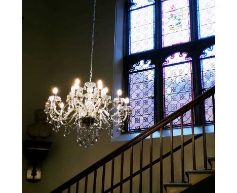 A pair of cut and moulded glass fifteen light chandeliers, 20th century, each sectional cut glass stem with fifteen scrolling