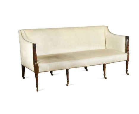 A Regency mahogany sofa, the rectangular padded back with turned column arm supports raised on four turned and tapered front 