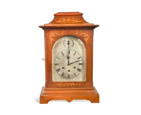 A stained mahogany chiming mantel clock by Gustav Becker, early 20th century,  the inlaid case with arched silvered flat dial