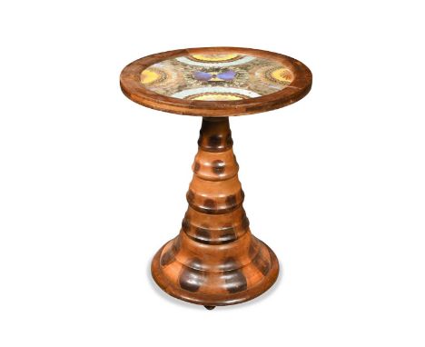 A monkey puzzle wood table, early 20th century, the circular top with glazed arrangement of butterfly wings upon a turned and