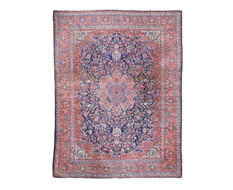 A finely-woven Kashan carpet, circa 1930, of typical design with a central medallion on an indigo ground488 x 322cmA good qua