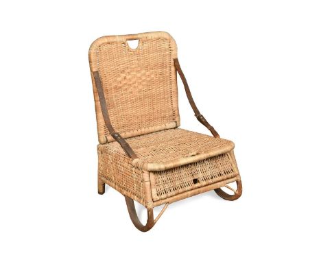 A vintage folding wicker fishing chair, circa 1920, with leather strap hinges and feet, and a compartment beneath the seat68 