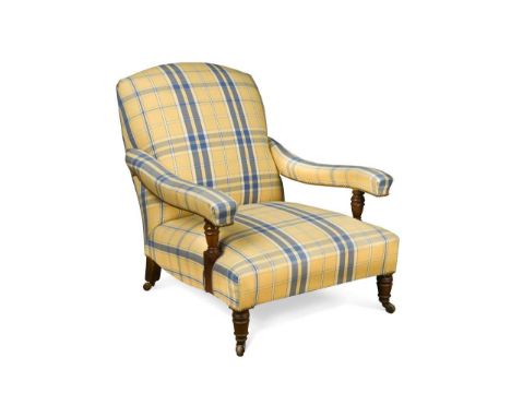 A mahogany framed armchair in the manner of Howard & Sons, circa 1880, of low and deep proportions and with gently curved 'fl
