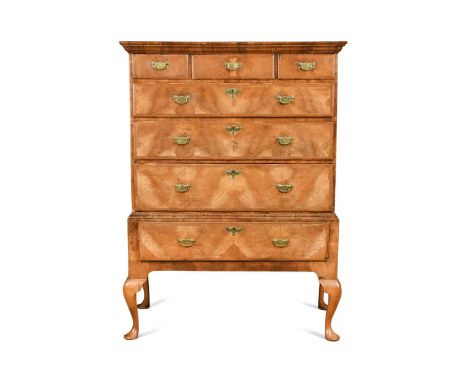 A walnut chest on stand, 18th century, the moulded top above three short over four long feather banded drawers raised on late