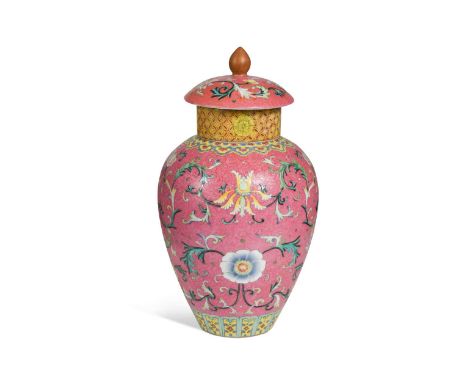 A Chinese famille rose porcelain vase and cover,   painted with interlacing lotus and flower heads against a feathery scroll 