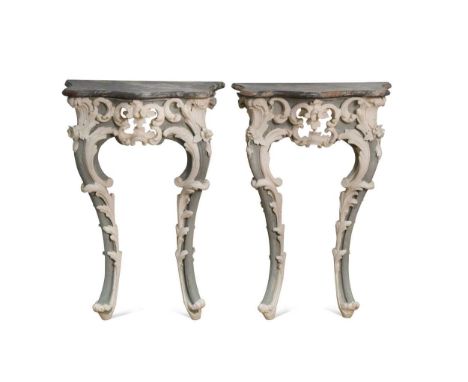 A pair of carved and painted pine console tables,   the serpentine fronted marble tops above a central pierced scroll work ca