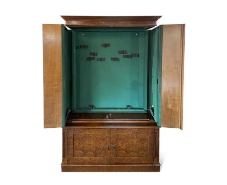 An eight gun security cabinet disguised as a burr walnut bookcase by 21st Century Antiques, a pair of bookshelf doors opening