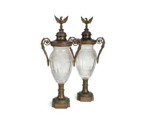 A pair of French cut glass and ormolu mounted pedestal vases and covers, 19th century, the ovoid bodies with "flying" acanthu