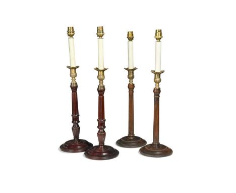 A pair of brass and mahogany candlestick lamps, 20th century  with vase-shaped nozzles and reeded columns on shallow domed ba