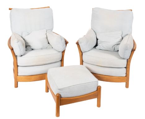 A pair of light oak and upholstered armchairs by Ercol, modern; each with slatted backs and sides, with light blue fabric cov