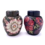 Two John Moorcroft pottery jars and covers,