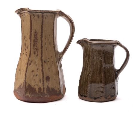 *Jim Malone [b. 1946] two stoneware jugs, of tapering cut sided form with pinched spout and with ribbed strap handle under as