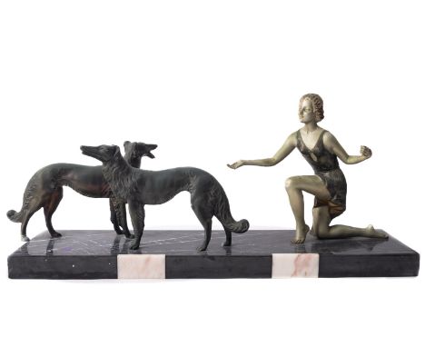 A painted metal and marble mounted figural group in Art Deco style, circa 1935; with a loosely draped maiden kneeling towards