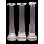 Patrick Stern [Contemporary] three clear glass vases with square base, fluted column and frill rim,