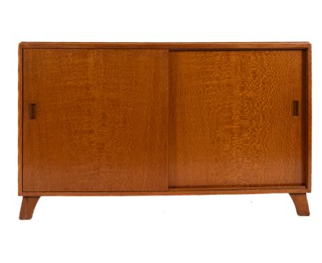 A light oak veneered sideboard, circa 1960s; the top with moulded edges, above twin sliding doors, a drawer within; on short 