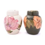 Two Moorcroft pottery jars and covers,