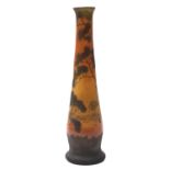 An Art Nouveau glass vase attributed to Legras of footed slender tapering form enamelled on an