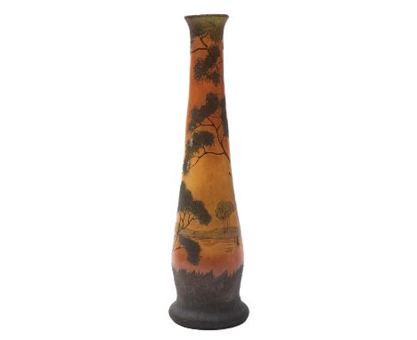 An Art Nouveau glass vase attributed to Legras of footed slender tapering form enamelled on an orange ground with an encircli