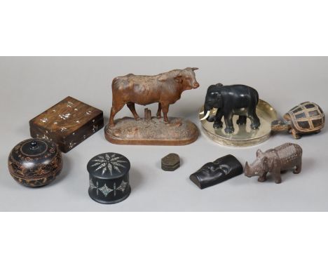 A Black Forest-style carved wooden model of a prize bull, on plinth base, 19cm wide x 16.5cm high; together with two treen tr