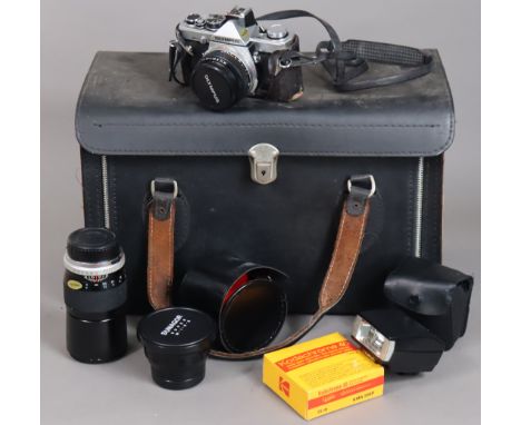 An Olympus “OM-2” camera; &amp; three camera lenses, with case.