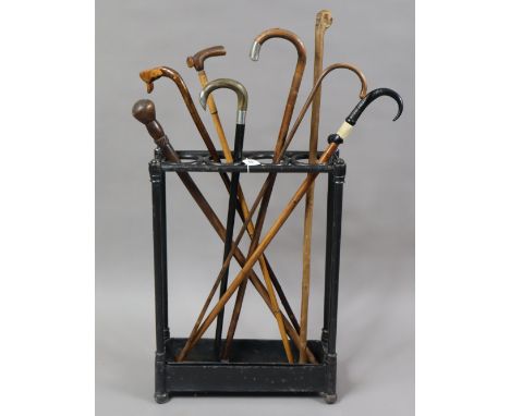A collection of eight various walking canes; two with silver mounts; &amp; a black painted cast-iron stick stand, 44.5cm wide