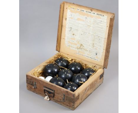 A set of eight Lignum Vitae lawn bowls &amp; two jacks, contained in a deal case.